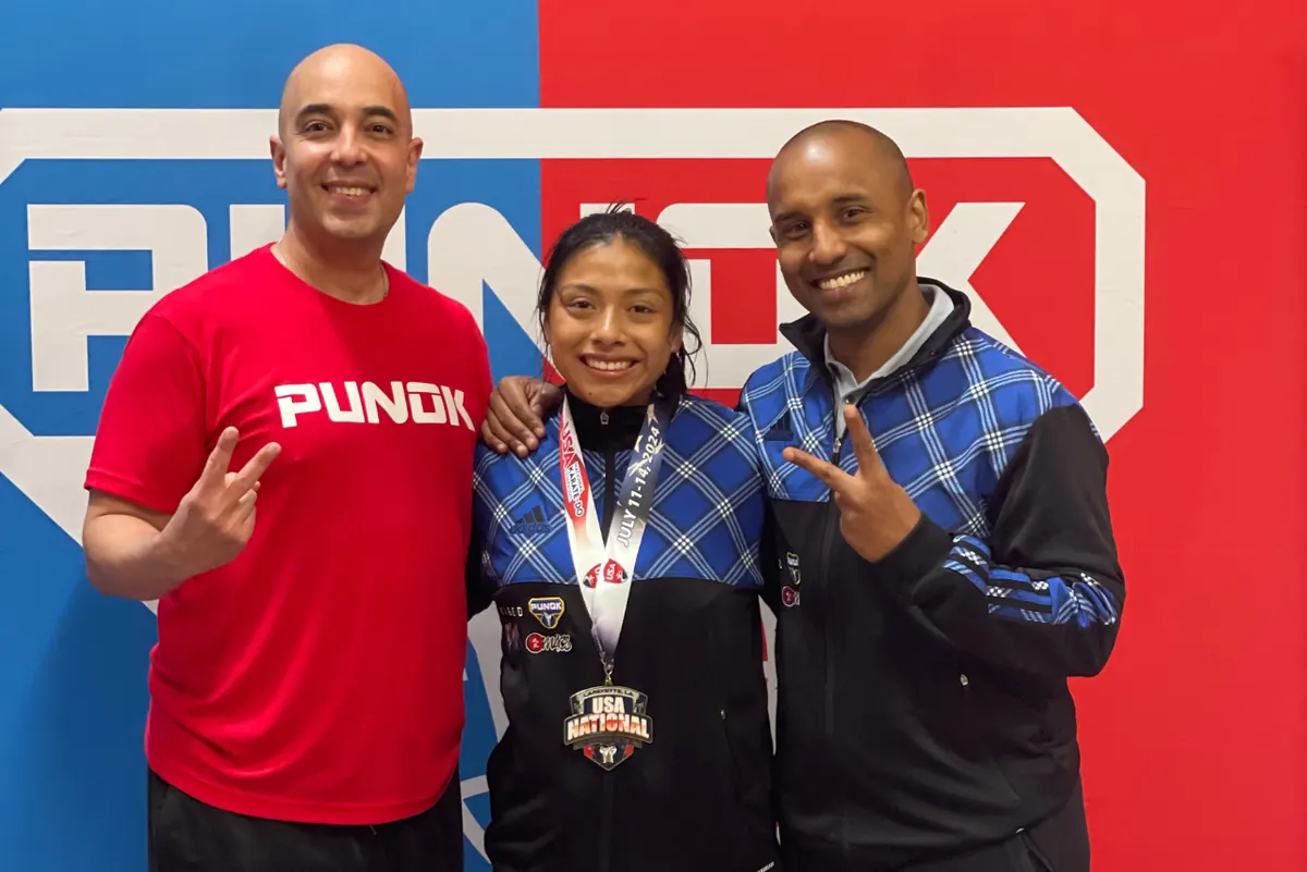 Glenhead Martial Arts instructors with a young karate medalist from Glen Head